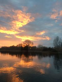 Scenic view of lake against sky during sunset