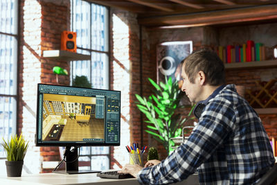 Side view of man working on table