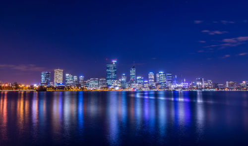 Illuminated city at waterfront