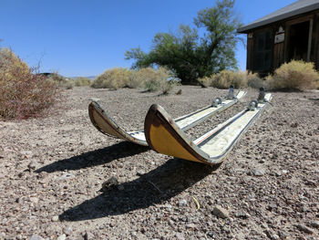 Close-up of skis against cottage in desert