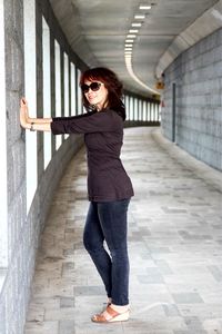 Portrait of woman standing in alley