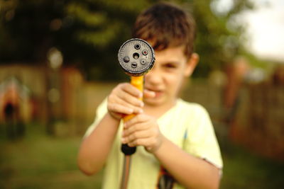 Full length of a boy holding camera