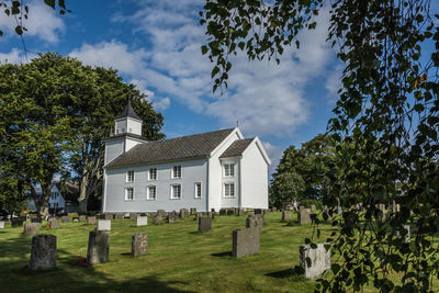 Trees and church against sky