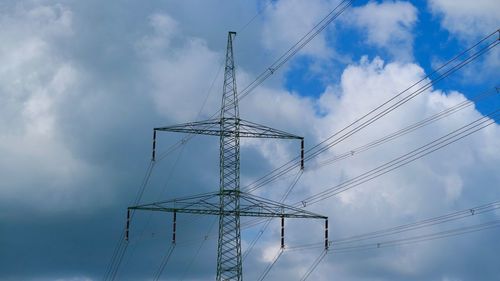 Low angle view of electricity pylon against sky