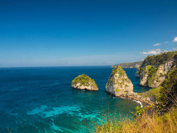 Scenic view of sea against clear blue sky