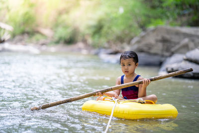 Active little girl playing at mountain stream