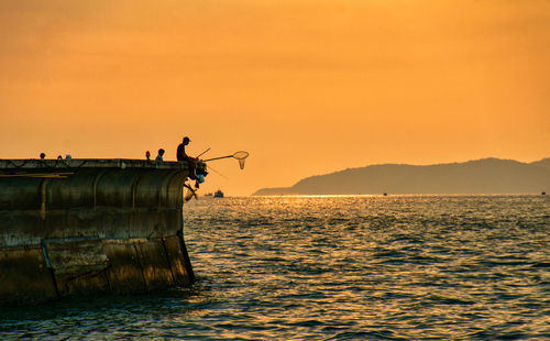 Scenic view of sea against sky during sunset