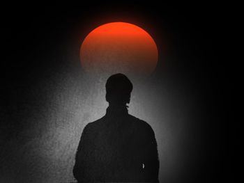 Silhouette of man against sky during sunset