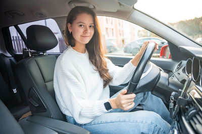 Smiling while sitting in car