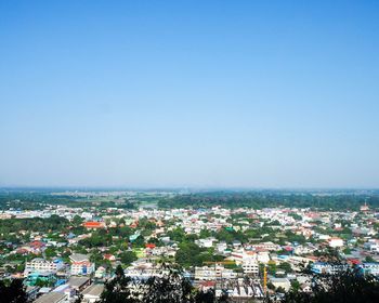 High angle view of buildings against clear blue sky