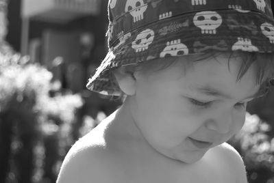 Close-up of cute shirtless boy wearing bucket hat