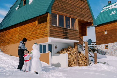 Rear view of woman standing on snow