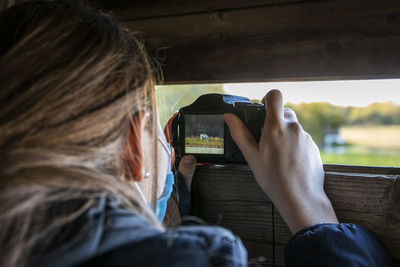 Midsection of woman using digital camera