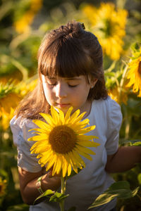 Low angle view of woman by sunflower