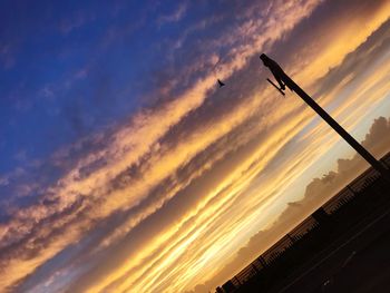 Low angle view of dramatic sky during sunset