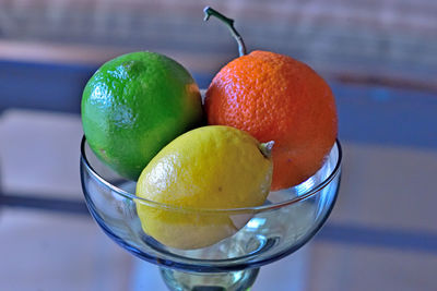 Close-up of fruits in glass bowl on table