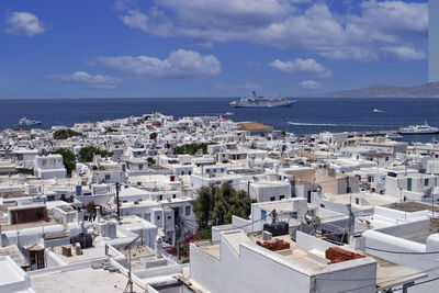 High angle view of townscape by sea against sky