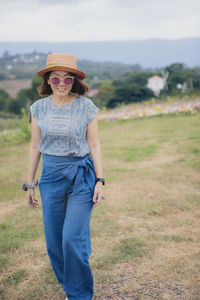 Asian woman standing outdoor with toothy smiling