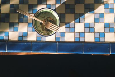 Directly above view of leftovers in bowl with fork on kitchen counter at home