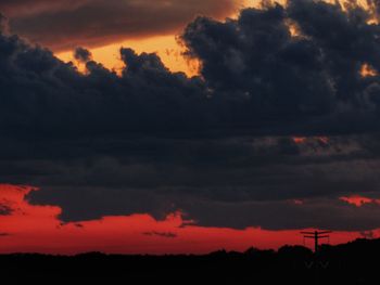 Scenic view of dramatic sky over silhouette landscape