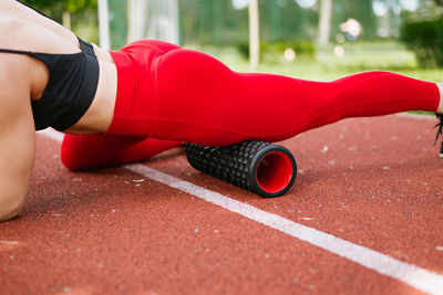 Low section of woman exercising on road