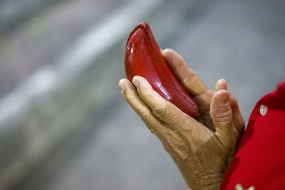 Close-up of hand holding strawberry