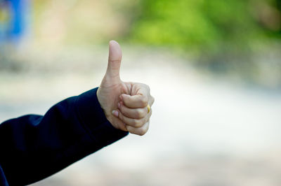 Cropped hand showing thumbs up