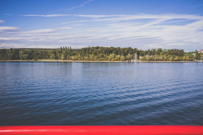 Scenic view of lake against cloudy sky