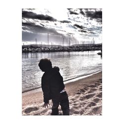 Silhouette of woman standing against cloudy sky