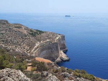 High angle view of rocks by sea against sky