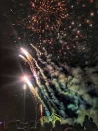 Low angle view of firework display at night