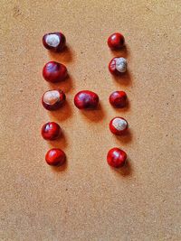 High angle view of cherries on sand