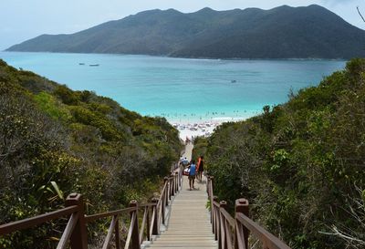 High angle view of people steps at beach against mountain