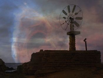 Low angle view of old building against cloudy sky
