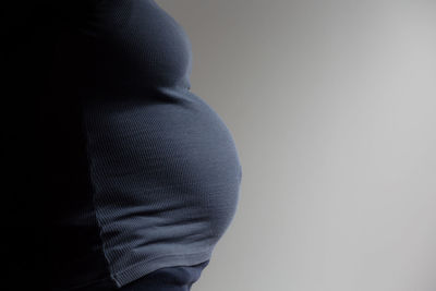 Close-up of man standing against white background