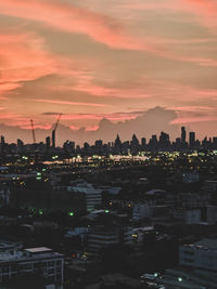 Silhouette buildings against sky during sunset