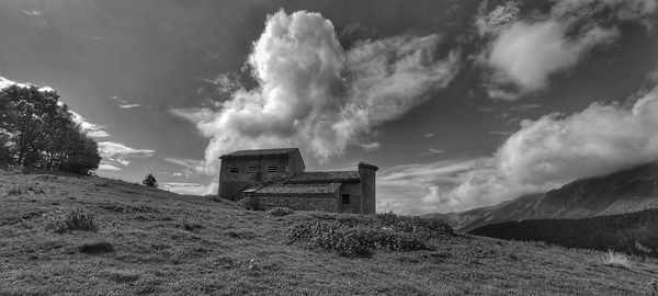 Low angle view of building on field against sky