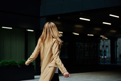 Rear view of woman walking in corridor