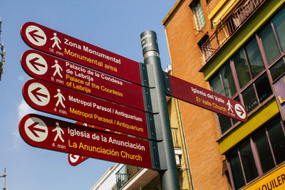 Low angle view of information sign against sky