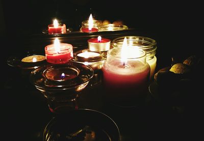 Close-up of lit candle in dark room