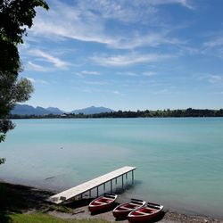 View of swimming pool by lake against sky