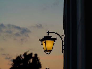 Silhouette street light against sky during sunset