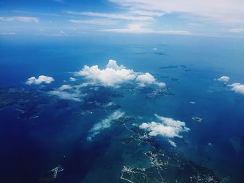 Aerial view of sea against blue sky