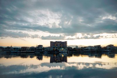 City by river against sky