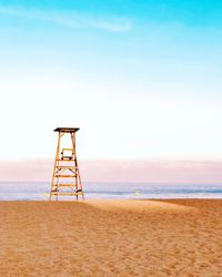 Lifeguard hut on beach against sky