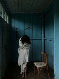 Rear view of boy sitting on chair