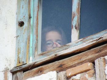 Portrait of woman seen through window