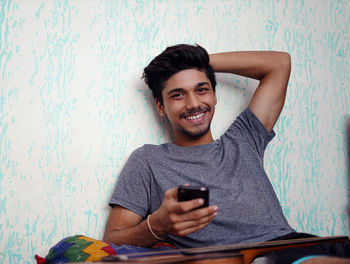 Portrait of young man using mobile phone