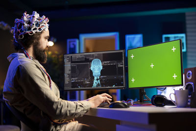 Side view of man working at office