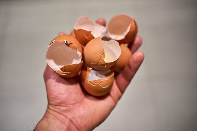 Hand with a handful of broken eggshells